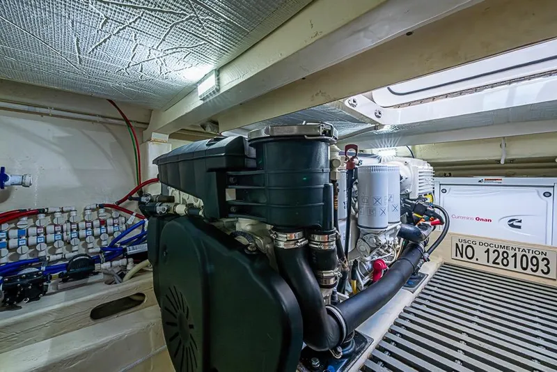 Slide: The Image of Engine room of a 2017 Tiara Yacht Coupe, featuring Cummins Onan generator and wiring. - 16