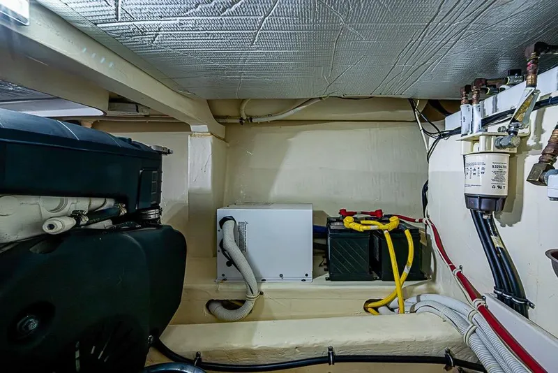 Slide: The Image of Engine room of a 2017 Tiara Yacht coupe, showcasing mechanical components and wiring. - 18