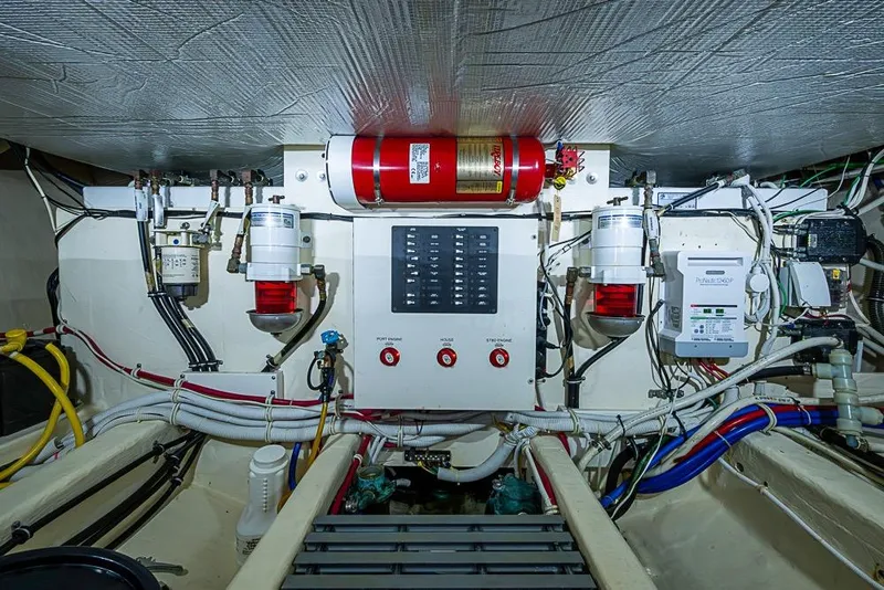 Slide: The Image of Engine room of a 2017 Tiara Yacht Coupe, featuring wiring and control systems. - 20