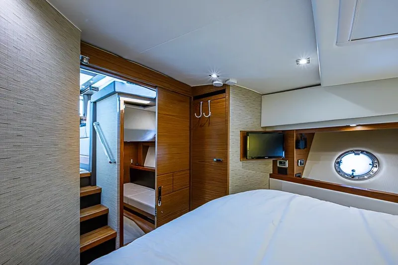 Slide: The Image of Luxurious 2017 Tiara Yacht coupe interior with modern bedroom and porthole window. - 22