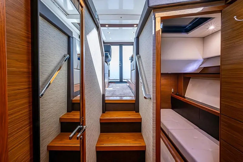 Slide: The Image of 2017 Tiara Yacht Coupe interior with wooden stairs and cozy cabin. - 25