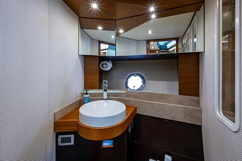 Slide: The Image of Luxurious 2017 Tiara Yacht coupe bathroom with modern sink and elegant wood accents. - 26