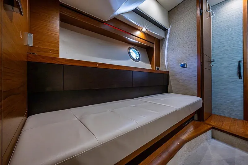 Slide: The Image of 2017 Tiara Yacht Coupe interior with sleek wood finish and comfortable seating. - 32