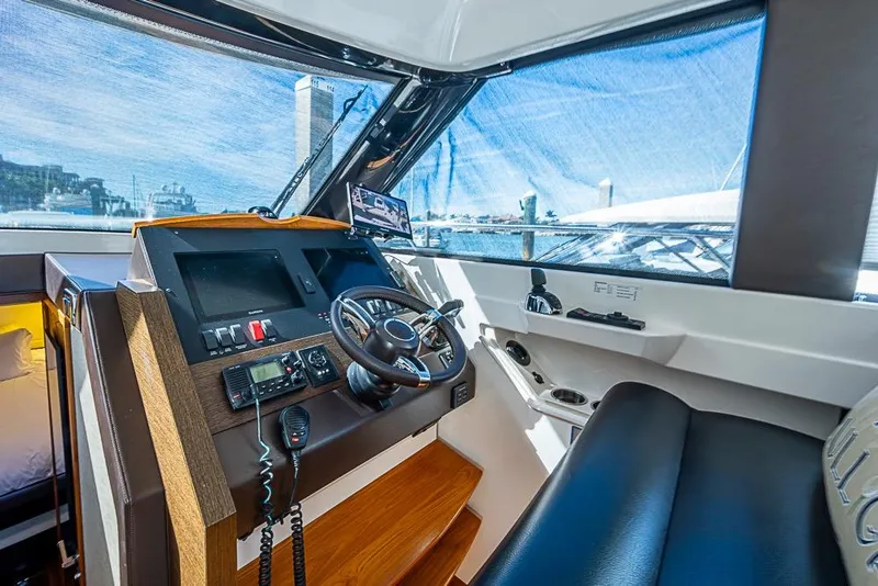 Slide: The Image of 2017 Tiara Yacht Coupe helm with modern controls and panoramic view. - 37