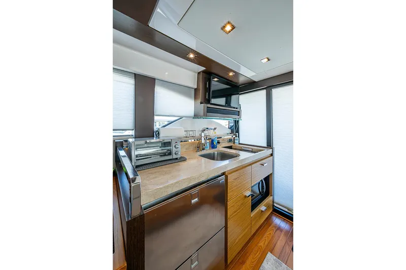 Slide: The Image of Modern kitchen interior of 2017 Tiara Yacht coupe with sleek appliances and wood accents. - 41
