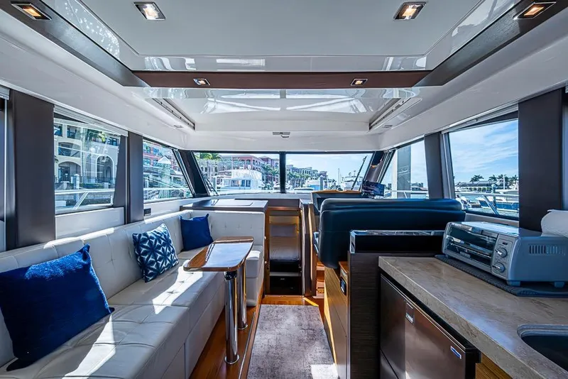 Slide: The Image of Luxurious interior of 2017 Tiara Yacht Coupe with modern furnishings and panoramic windows. - 44