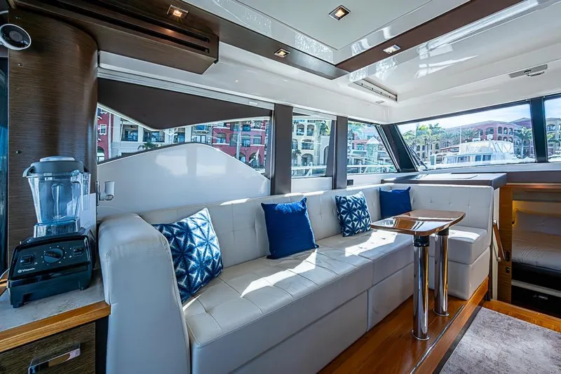 Slide: The Image of Luxurious 2017 Tiara Yacht coupe interior with white seating, blue cushions, and modern design. - 45