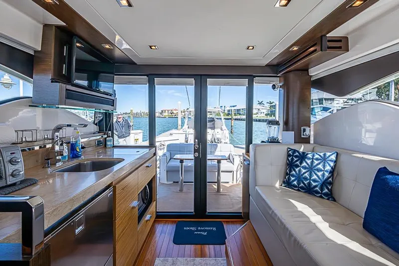 Slide: The Image of Luxurious interior of a 2017 Tiara Yacht coupe with modern kitchen and seating area. - 49