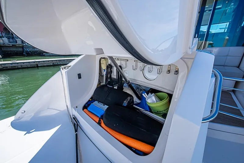 Slide: The Image of 2017 Tiara Yacht coupe storage compartment with various boating accessories and equipment. - 53