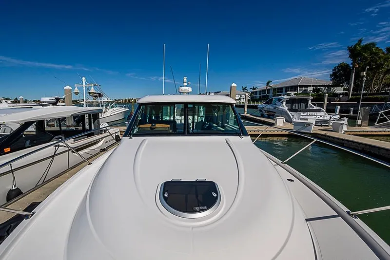 Slide: The Image of 2017 Tiara Yacht Coupe docked at marina under clear blue sky. - 8