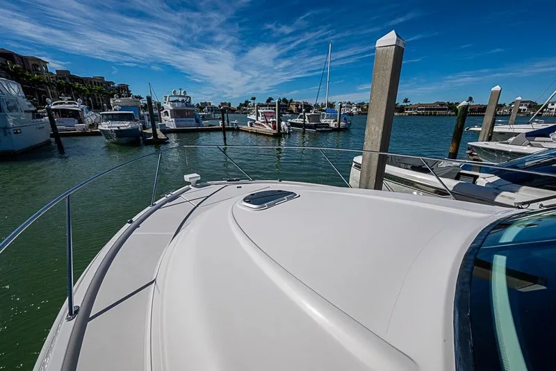 Slide: The Image of 2017 Tiara Yacht coupe docked in a marina under a clear blue sky. - 9