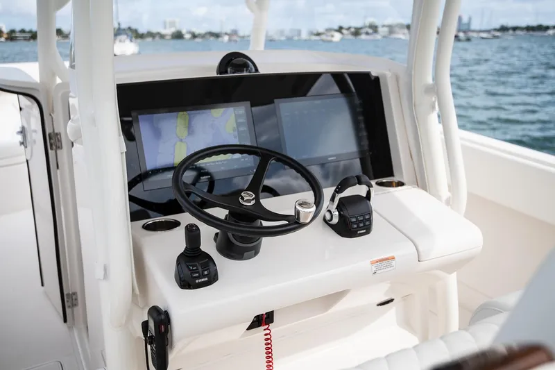 Slide: The Image of Manufacturer Provided Image: Helm of 2026 Jupiter 38 boat with modern navigation equipment and steering wheel. - 6