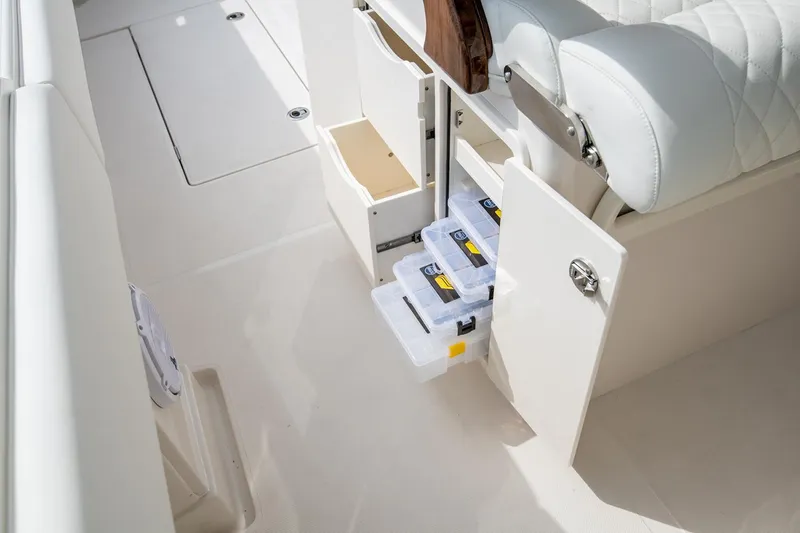 Slide: The Image of Manufacturer Provided Image: Storage compartments on a 2026 Jupiter 38 boat, featuring organized tackle boxes. - 9
