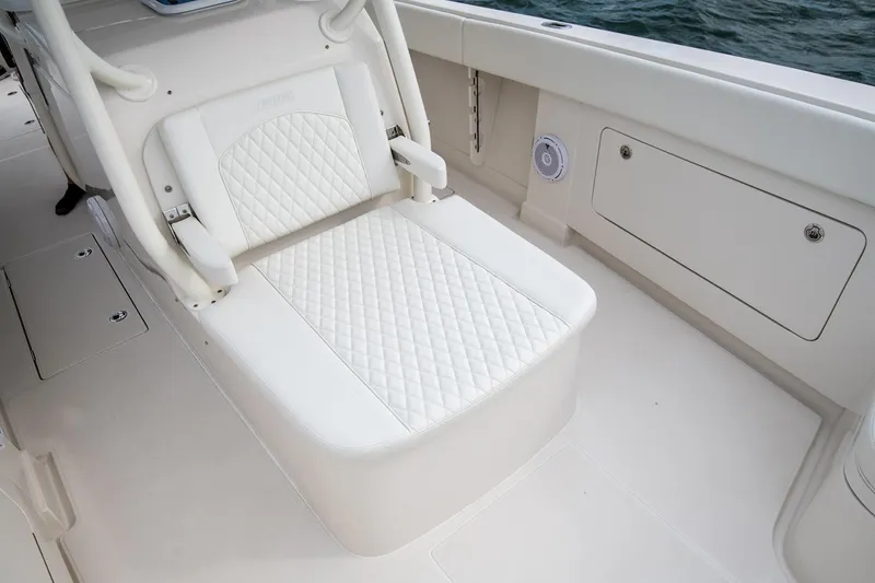 Slide: The Image of Manufacturer Provided Image: Luxurious seating on 2026 Jupiter 38 boat with quilted white upholstery. - 5