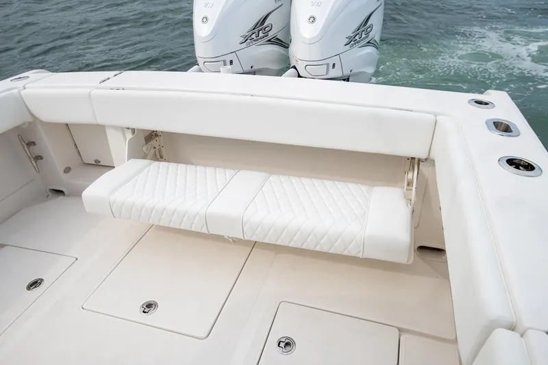 Slide: The Image of Manufacturer Provided Image: 2026 Jupiter 38 boat with white cushioned seating and dual outboard motors on the water. - 7