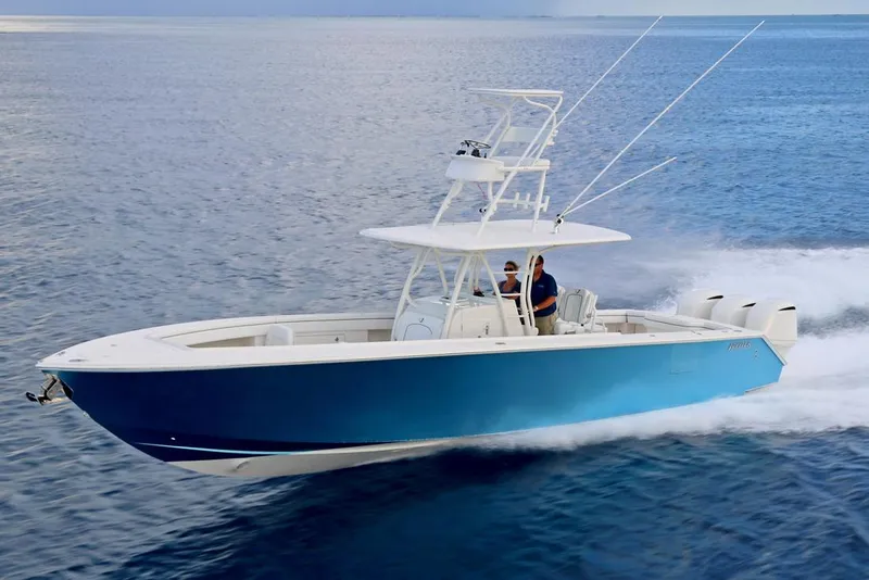 Slide: The Image of Manufacturer Provided Image: 2026 Jupiter 38 boat cruising on open water, featuring sleek blue design and powerful engines. - 2