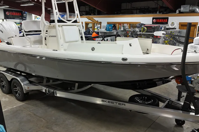 The Image of 2026 Skeeter SX2350 boat on trailer in showroom, featuring Yamaha engine. - 0