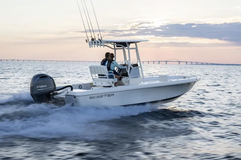 Slide: The Image of Manufacturer Provided Image: 2026 Skeeter SX2350 boat cruising on open water at sunset. - 11