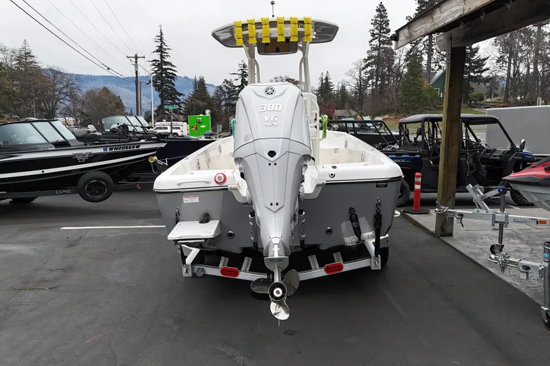 Slide: The Image of 2026 Skeeter SX2350 boat with powerful outboard motor, parked outdoors. - 19