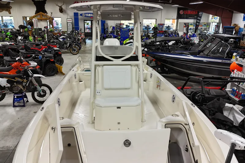 Slide: The Image of 2026 Skeeter SX2350 boat displayed in a showroom with motorcycles and ATVs. - 2