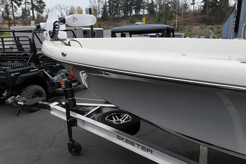 Slide: The Image of 2026 Skeeter SX2350 boat on trailer, parked outdoors near vehicles. - 20