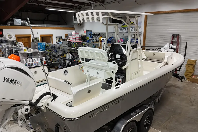 Slide: The Image of 2026 Skeeter SX2350 boat with Yamaha engine in showroom, surrounded by marine equipment. - 24