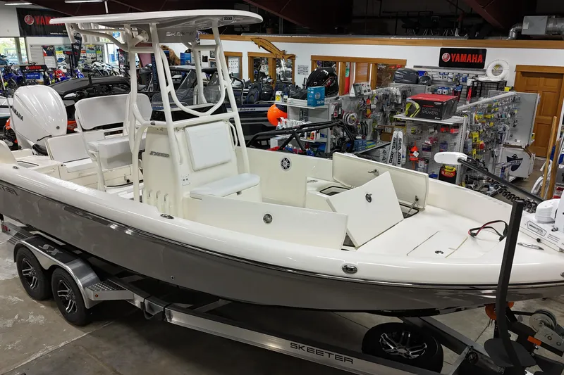 Slide: The Image of 2026 Skeeter SX2350 boat displayed in a showroom, featuring open storage compartments. - 3