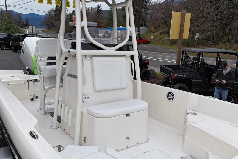 Slide: The Image of 2026 Skeeter SX2350 boat interior with seating and storage, parked near road and vehicles. - 6