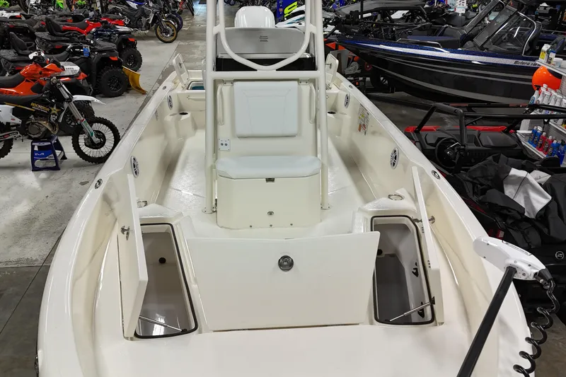 Slide: The Image of 2026 Skeeter SX2350 boat interior in showroom with motorcycles and ATVs. - 7