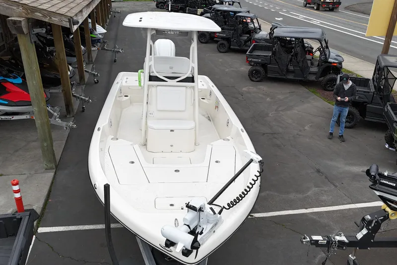 Slide: The Image of 2026 Skeeter SX2350 boat displayed in a dealership lot with off-road vehicles. - 9