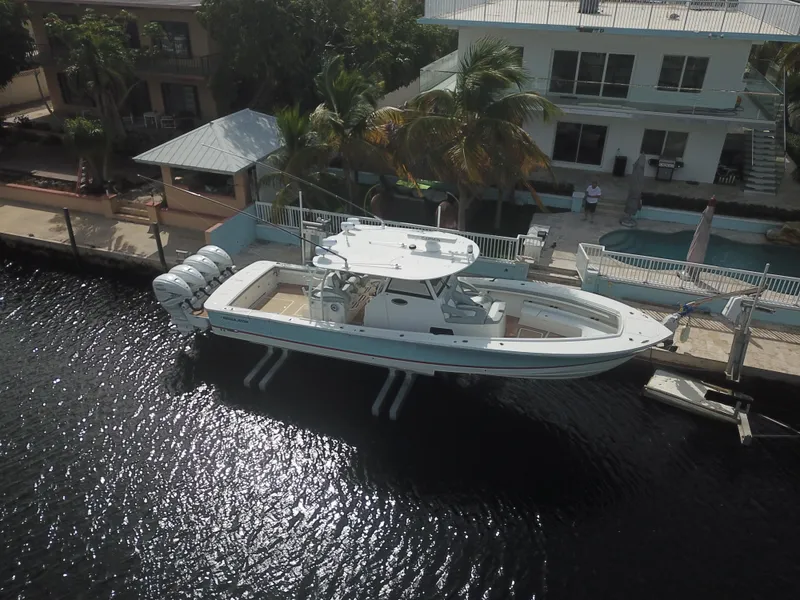 Slide: The Image of 2022 Regulator 41 boat docked by waterfront home, aerial view. - 10