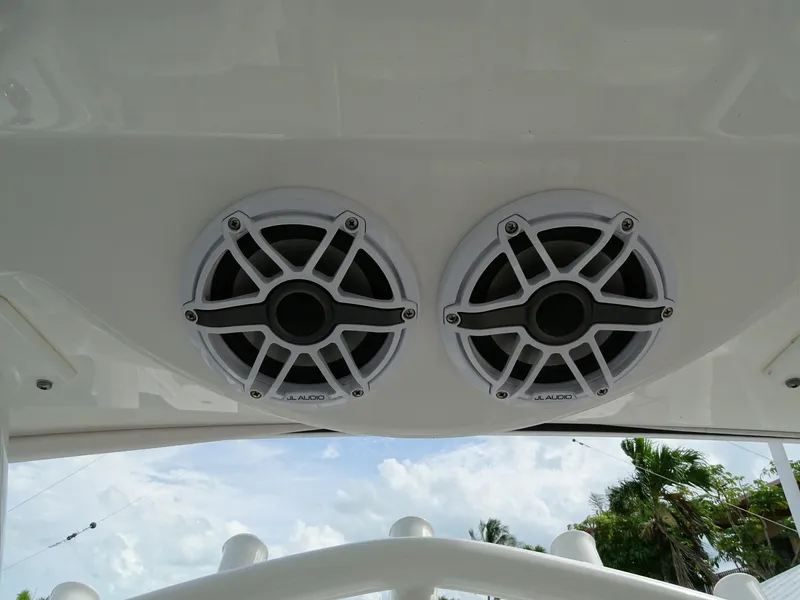 Slide: The Image of 2022 Regulator 41 boat speakers, mounted on white surface, with sky and trees in background. - 29