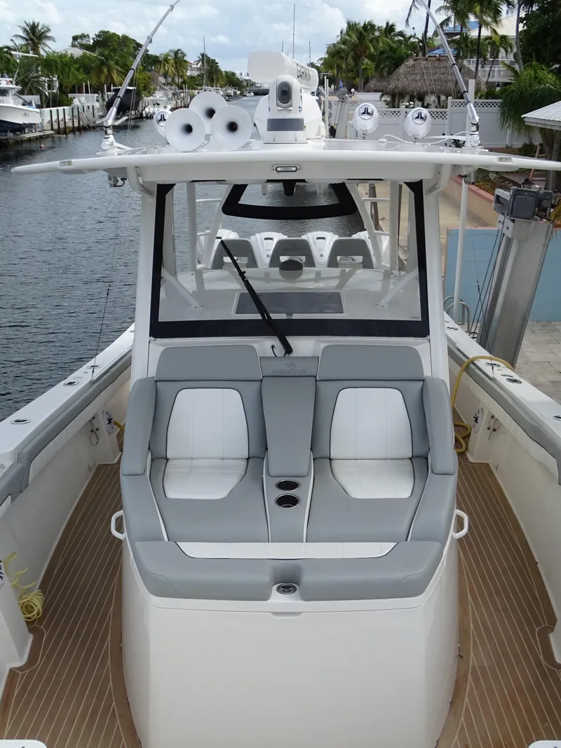 Slide: The Image of 2022 Regulator 41 boat with sleek seating, docked by a canal. - 31