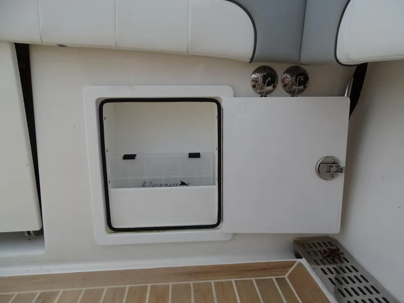 Slide: The Image of Open storage compartment on 2022 Regulator 41 boat with teak flooring. - 43