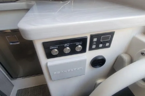 Slide: The Image of Control panel of a 2022 Regulator 41 boat with switches and digital display. - 44