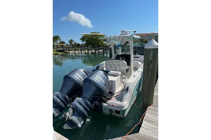 Slide: The Image of 2019 Robalo R242 Center Console boat docked with twin Yamaha engines. - 3