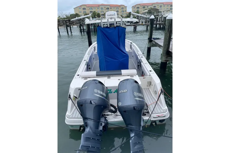 Slide: The Image of 2019 Robalo R242 Center Console boat with twin Yamaha 150 engines docked in marina. - 6