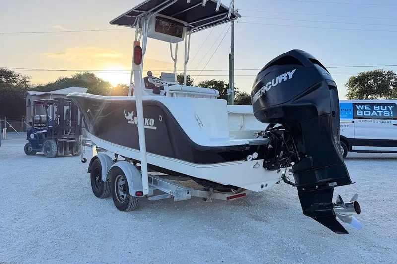 Slide: The Image of 2013 Mako 204 Center Console boat with Mercury engine on trailer at sunset. - 3