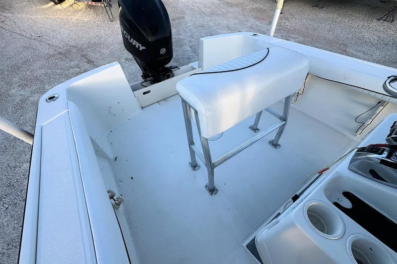 Slide: The Image of 2013 Mako 204 Center Console boat interior with seating and Mercury outboard motor. - 6