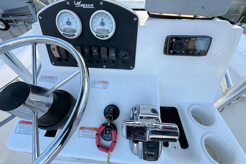 Slide: The Image of 2013 Mako 204 Center Console dashboard with steering wheel and control panel. - 7