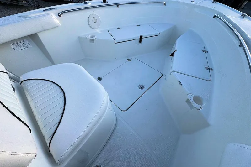 Slide: The Image of 2013 Mako 204 Center Console boat interior with seating and storage compartments. - 8