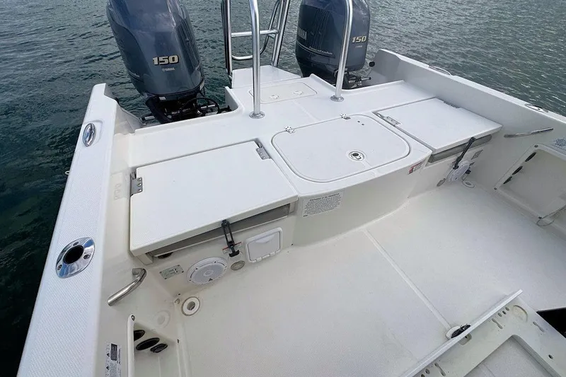 Slide: The Image of 2021 World Cat 235 CC boat deck with dual Yamaha 150 engines on water. - 10