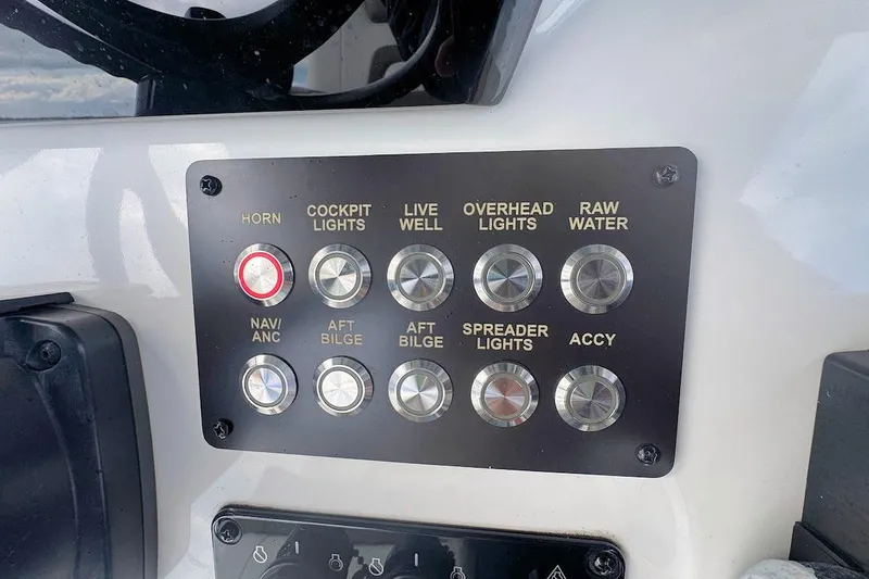 Slide: The Image of Control panel of a 2021 World Cat 235 CC boat with labeled buttons. - 14