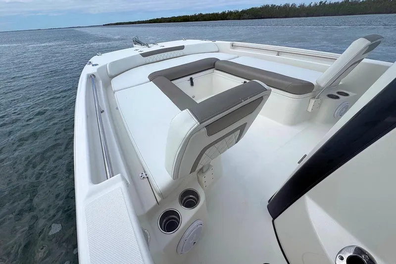 Slide: The Image of 2021 World Cat 235 CC boat interior with seating, on calm water. - 18