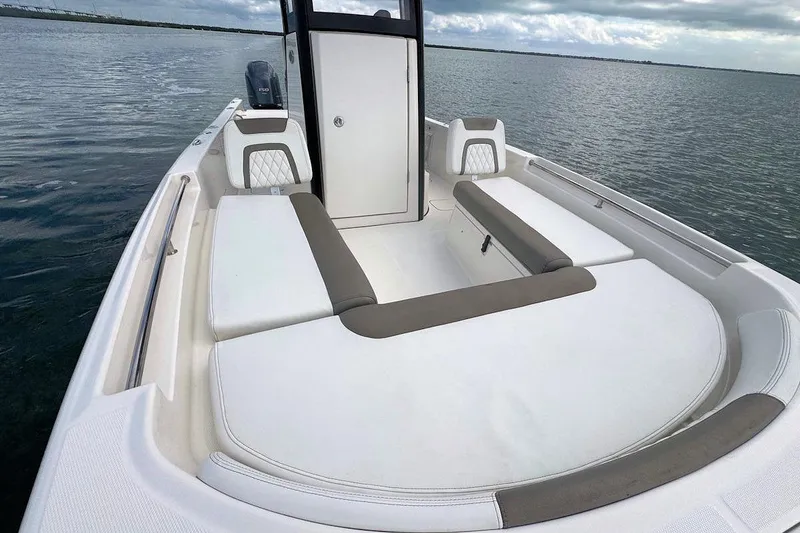 Slide: The Image of 2021 World Cat 235 CC boat with spacious seating on calm waters. - 21
