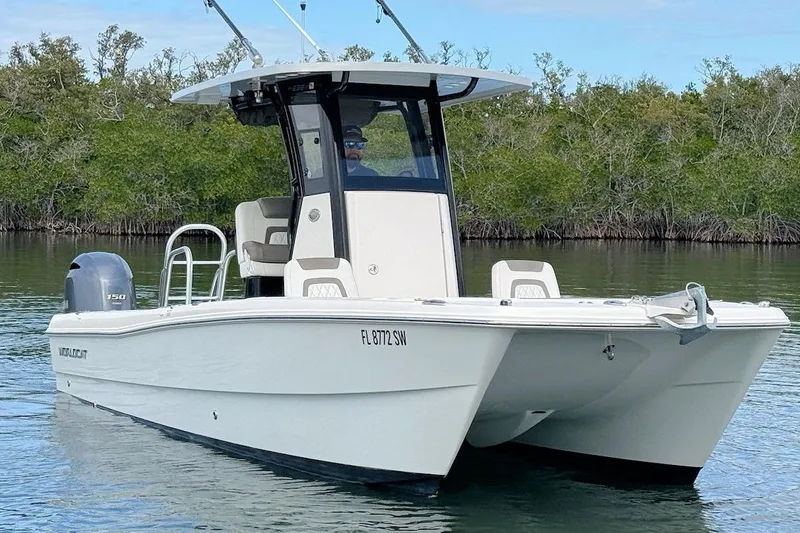 Slide: The Image of 2021 World Cat 235 CC boat on calm water, featuring sleek design and powerful engine. - 3