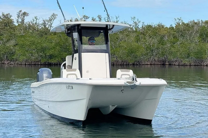Slide: The Image of 2021 World Cat 235 CC boat cruising on calm water near mangroves. - 4