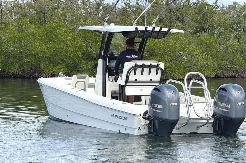 Slide: The Image of 2021 World Cat 235 CC boat with dual Yamaha engines on calm water. - 8