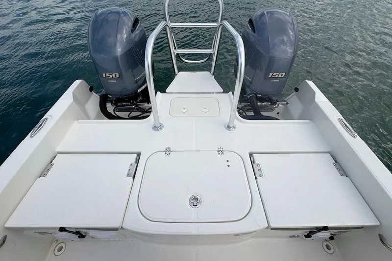 Slide: The Image of 2021 World Cat 235 CC boat with dual Yamaha 150 engines on water. - 9