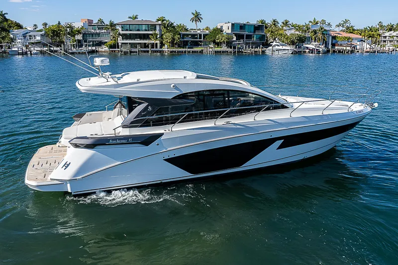 Slide: The Image of 2022 Beneteau Gran Turismo 45 luxury yacht cruising in a scenic waterfront area. - 16